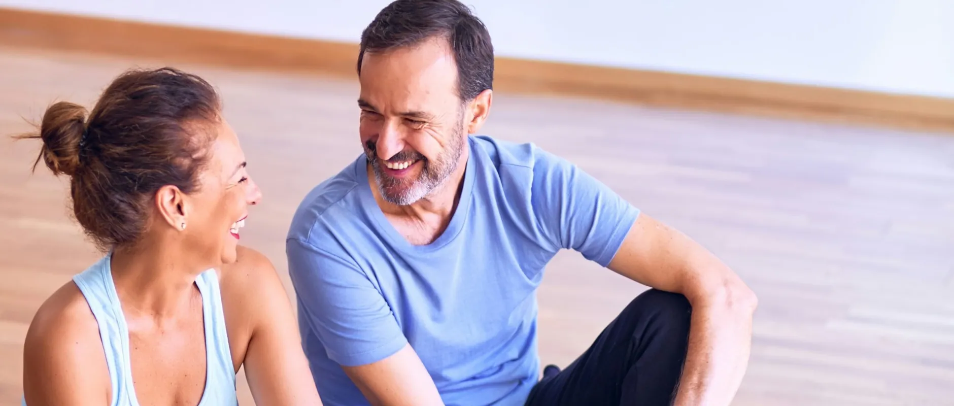 Couple smiling together during a break from exercise